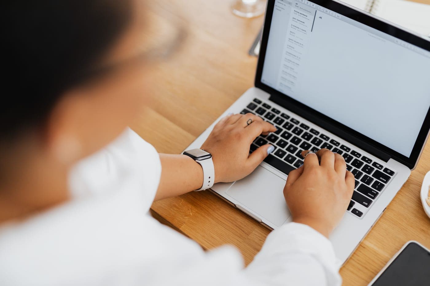 Someone writing an email on a laptop