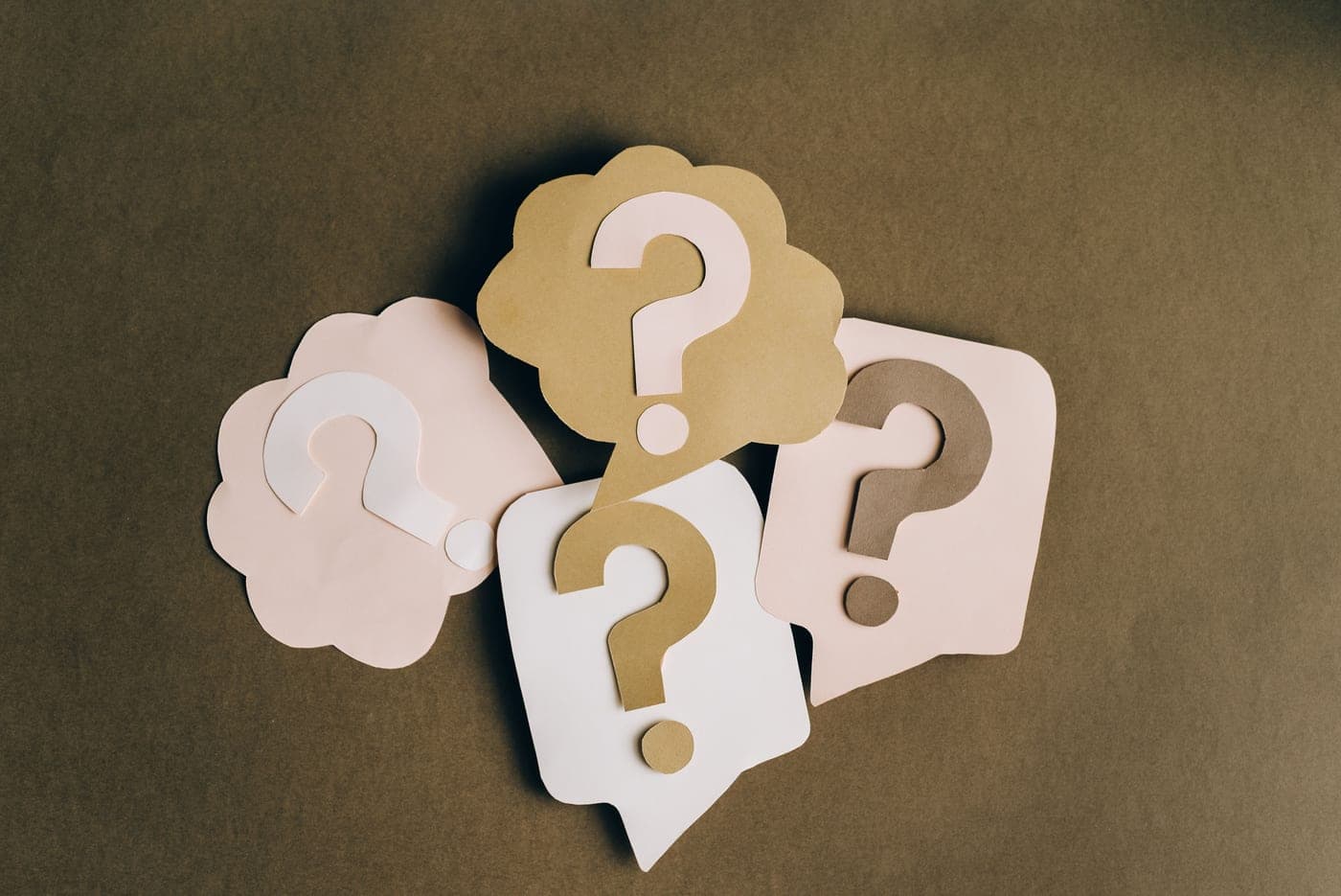 Question marks written on sheets of paper