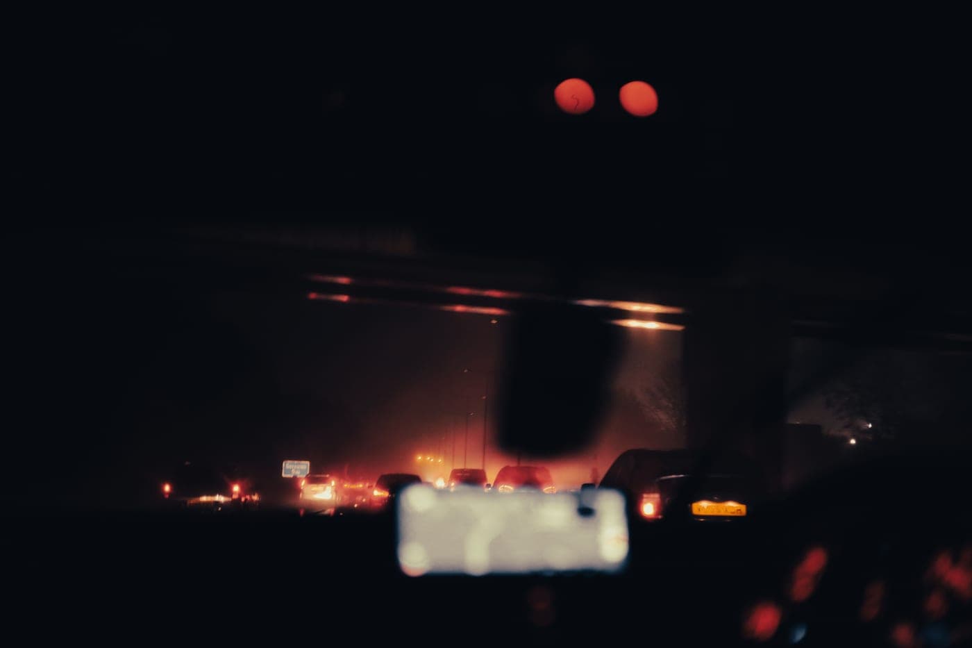 A car on an unlit road at night