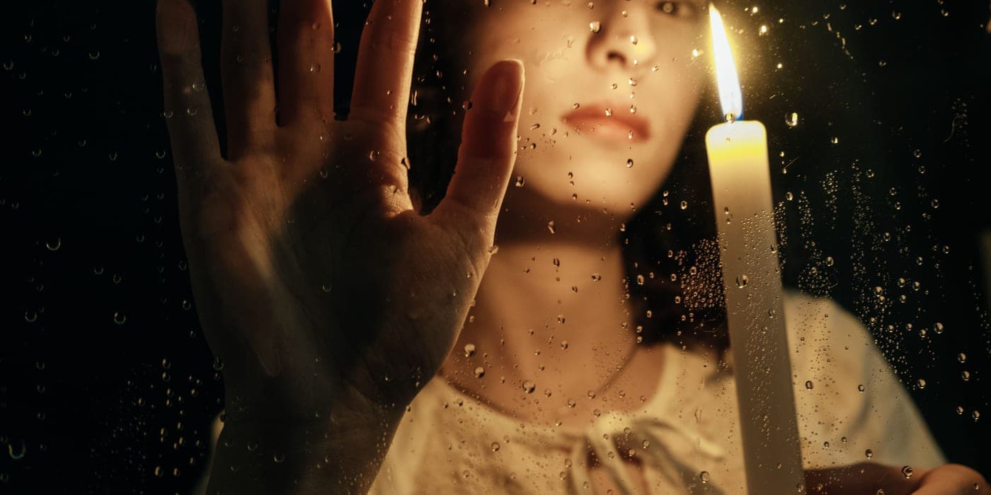A candle lighting a dark room during a power cut