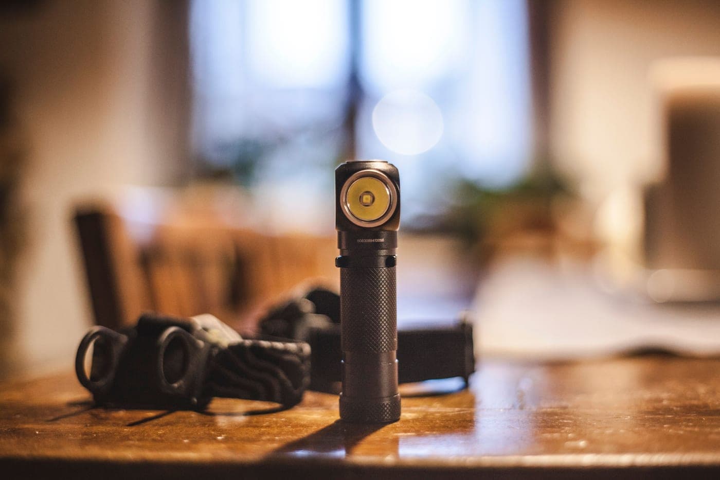 An inexpensive flashlight lying on a wooden workbench