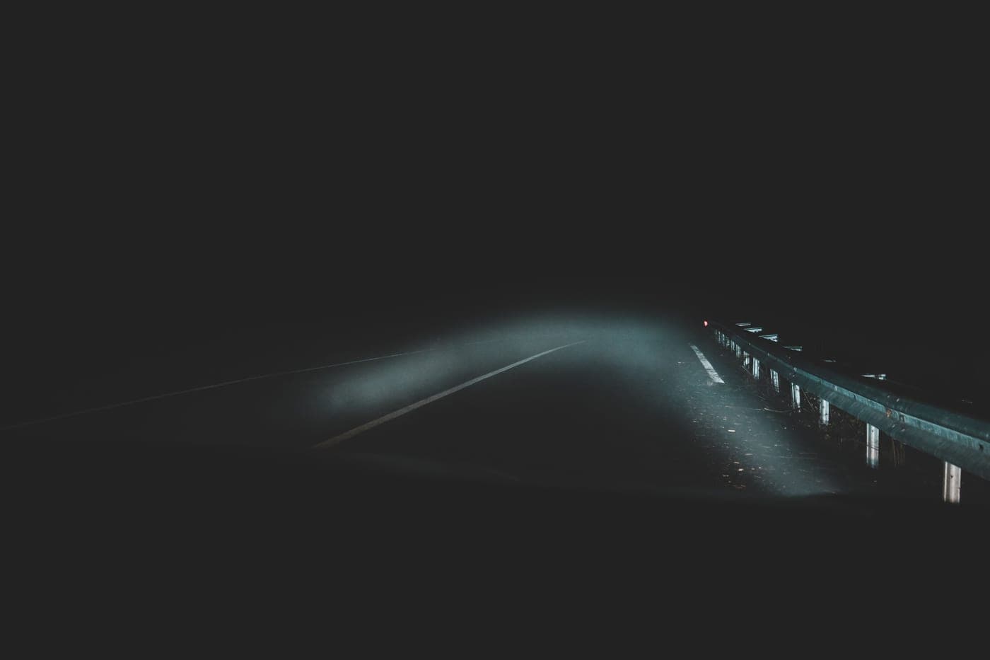 A bright beam of light cutting through fog at night