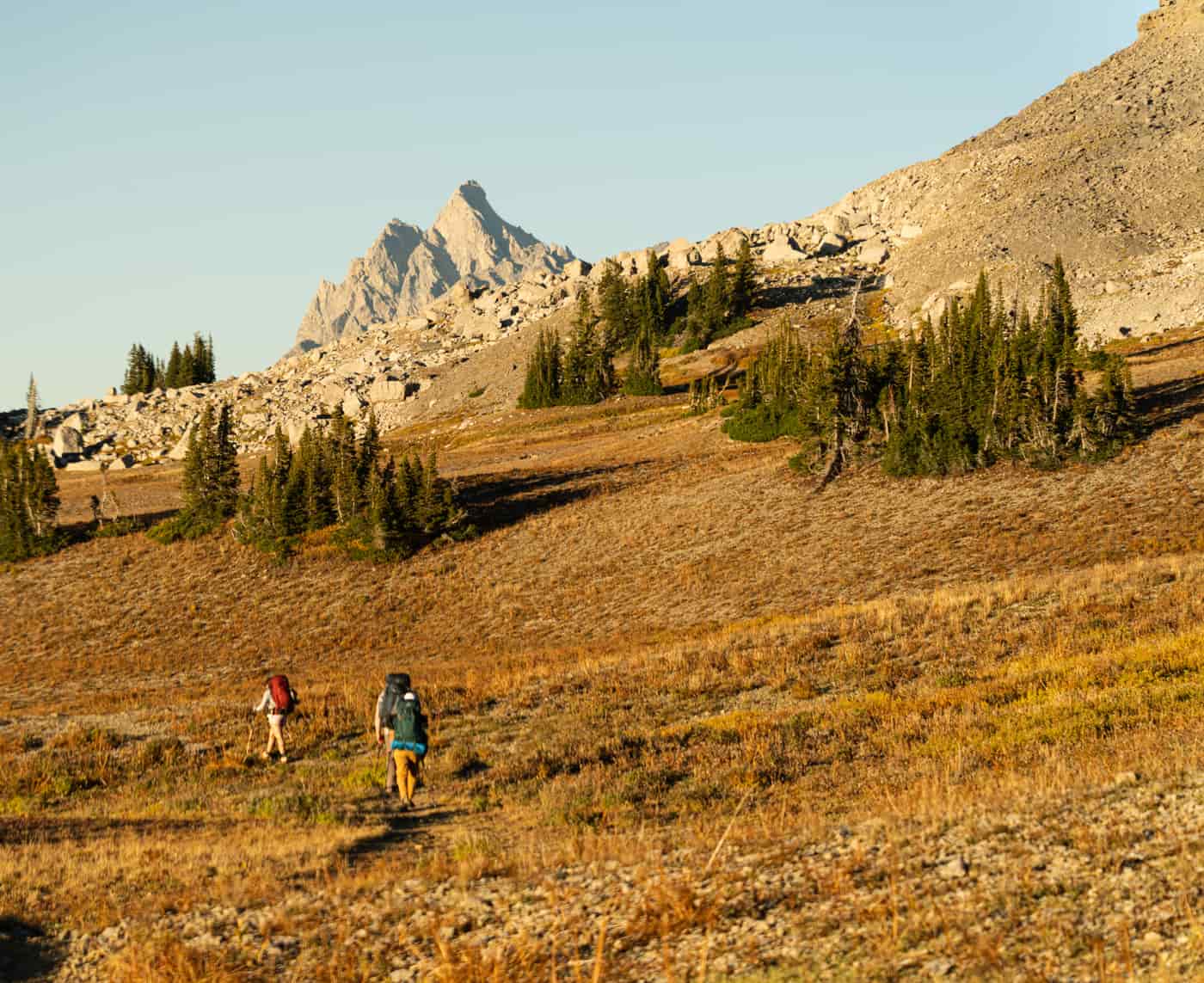 Two hikers on a mountain trail in fall