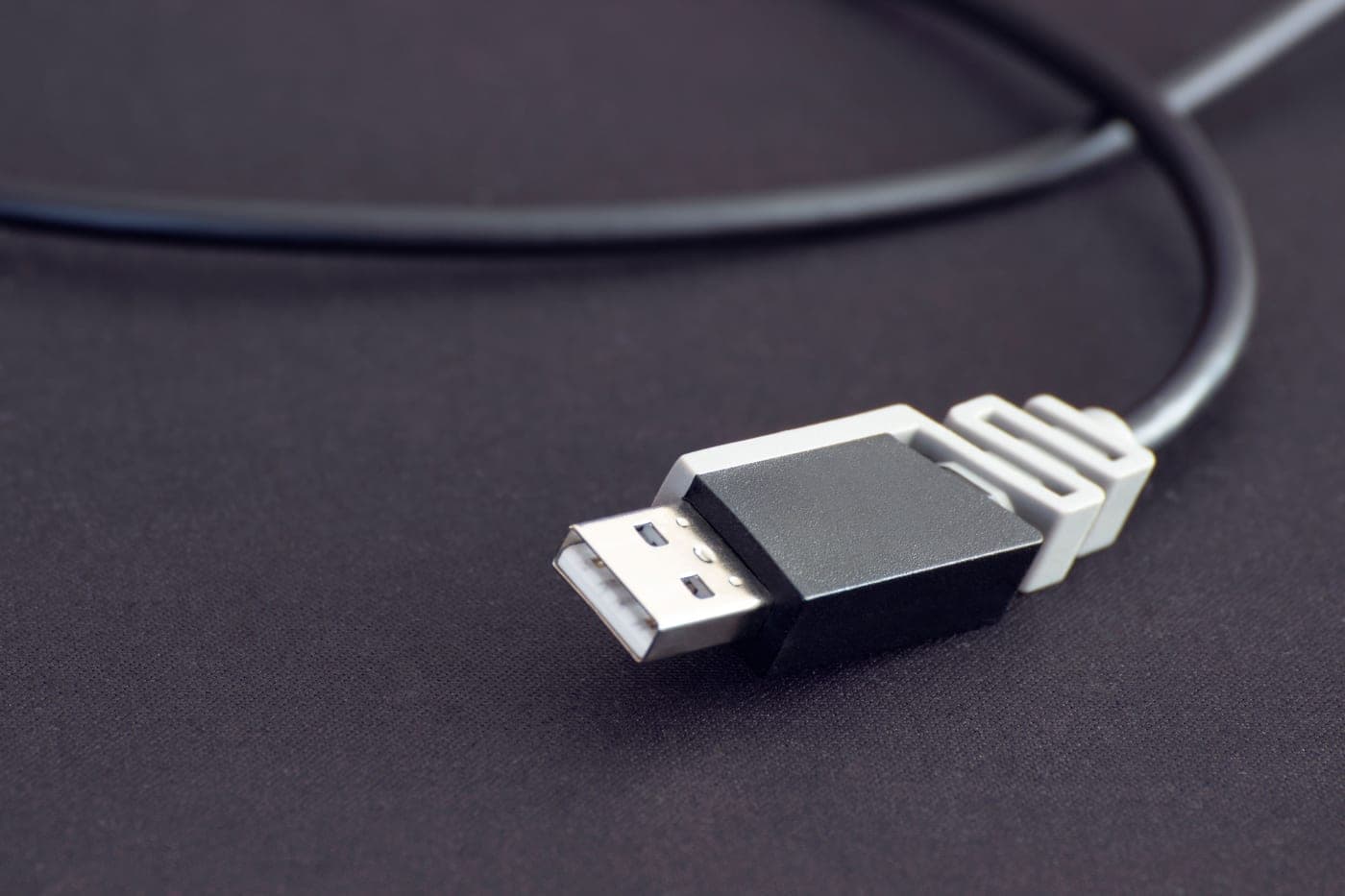 A USB charging cable coiled on a dark surface