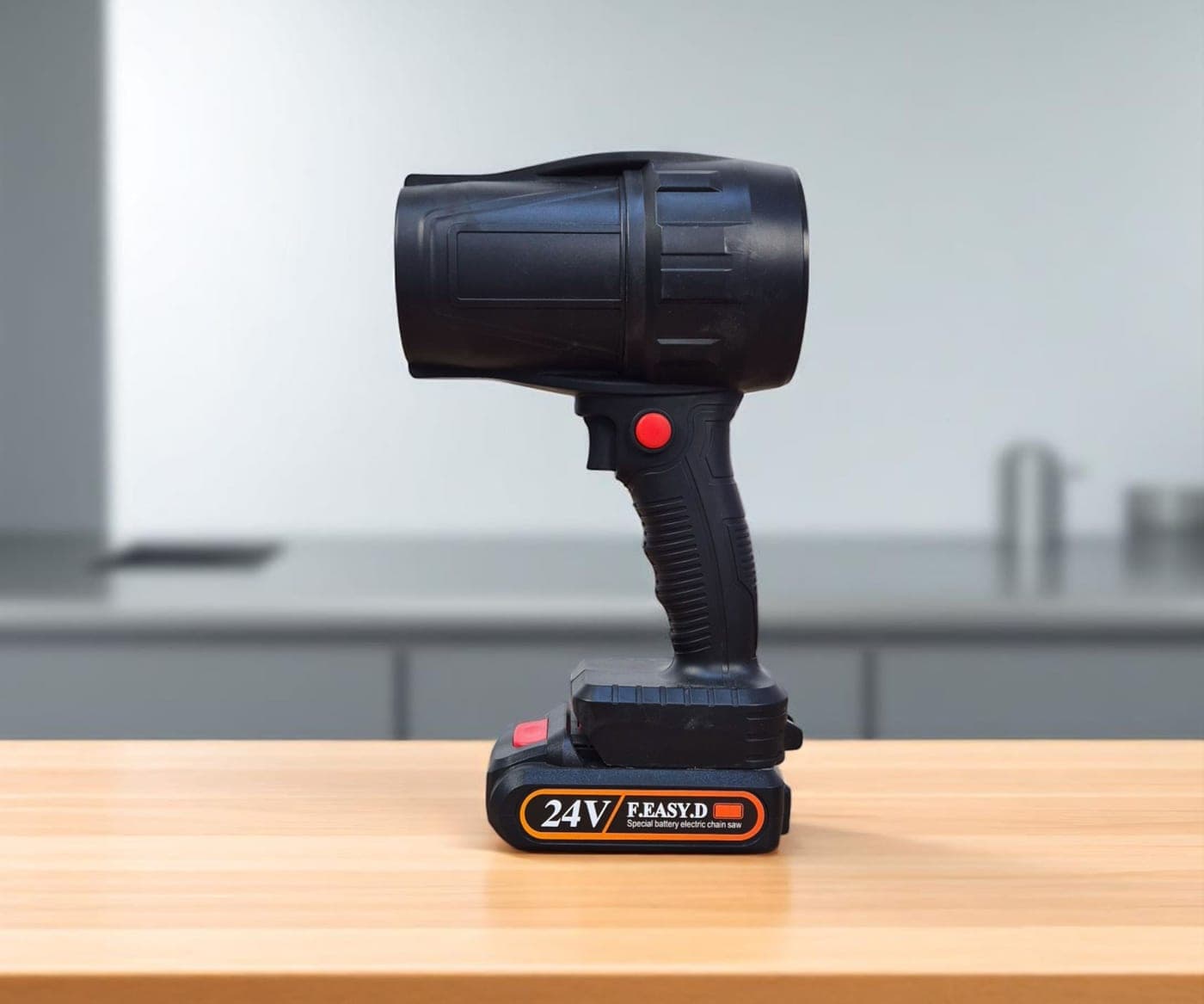 A black cordless handheld spotlight resting on a wooden desk