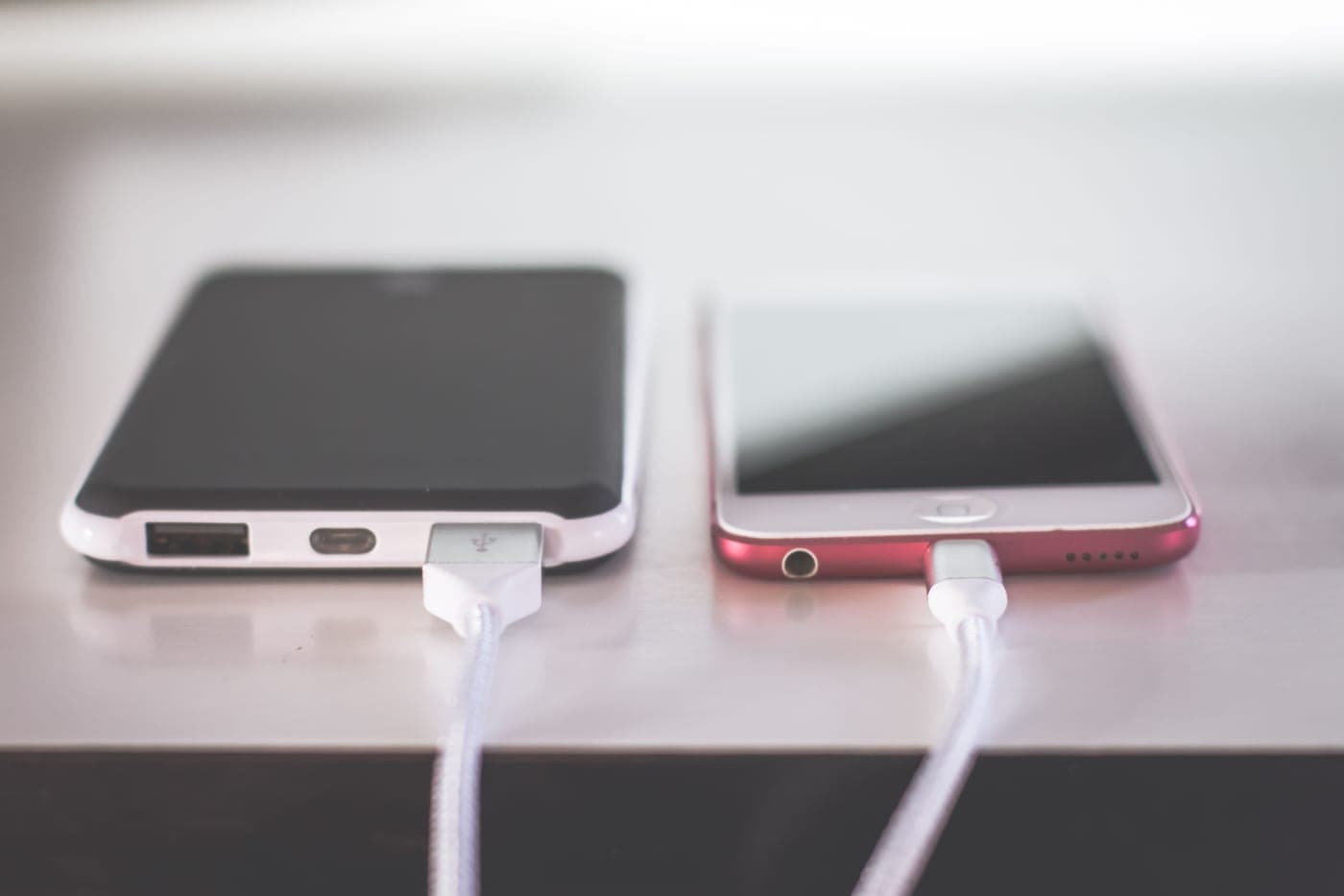 A charging cable plugged into a device on a dark surface