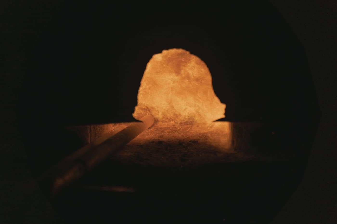 Glowing hot metal in a darkened workshop