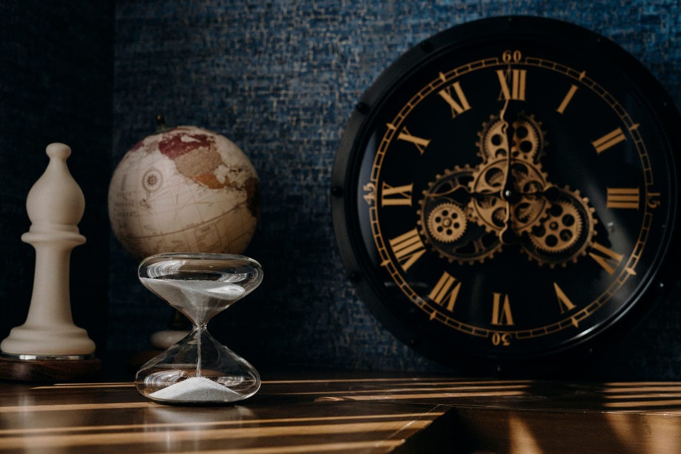 An hourglass standing on a dark tabletop