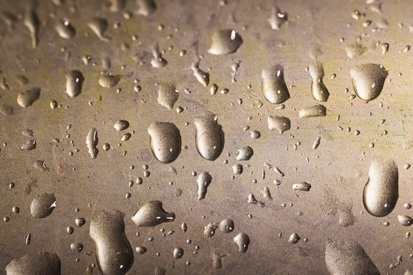 Water droplets beaded on a metal surface