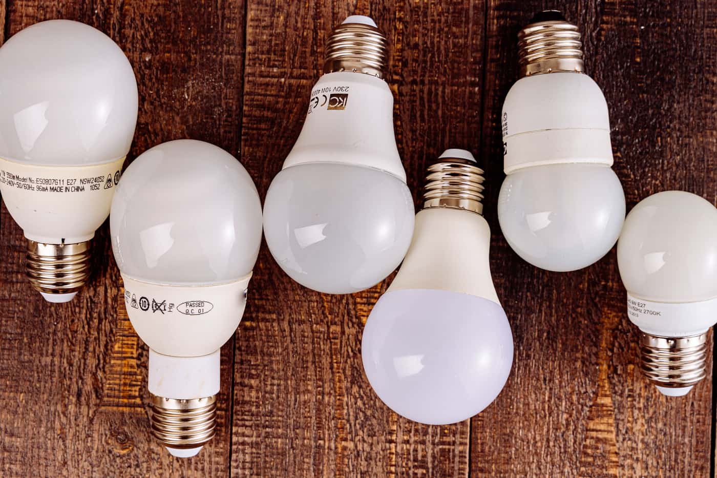 An old incandescent bulb beside a modern LED bulb