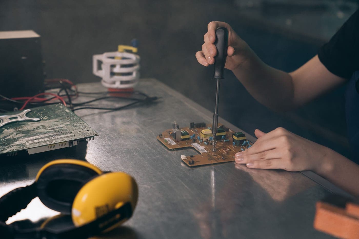 A small screwdriver being used to work on an electronic device