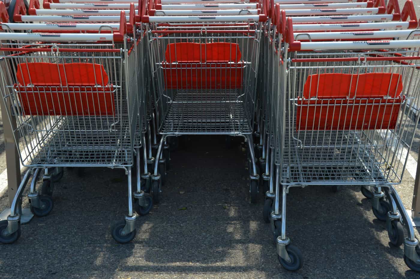 A shopping cart in the aisle of a large store
