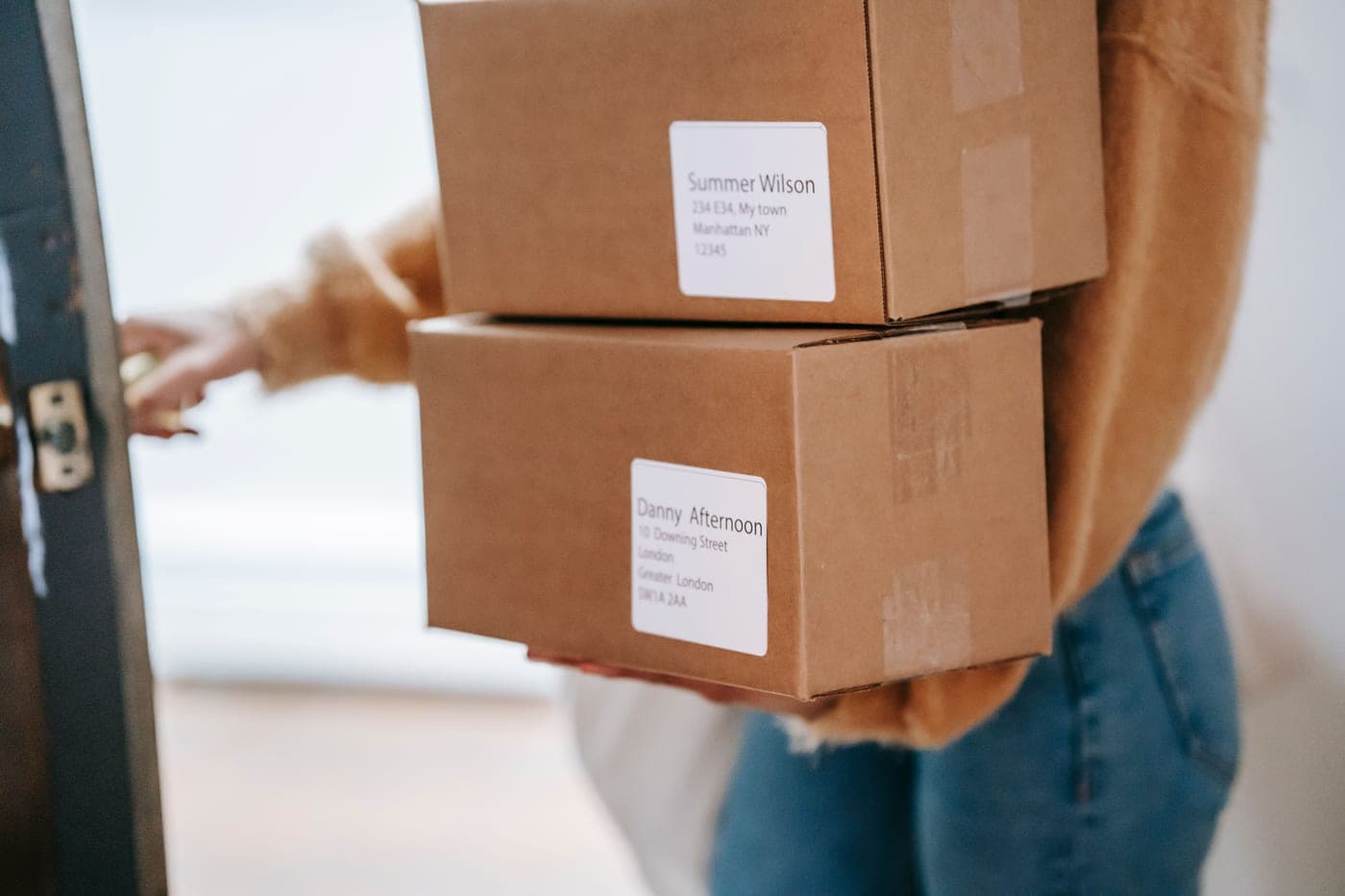 Cardboard delivery boxes stacked by a front door