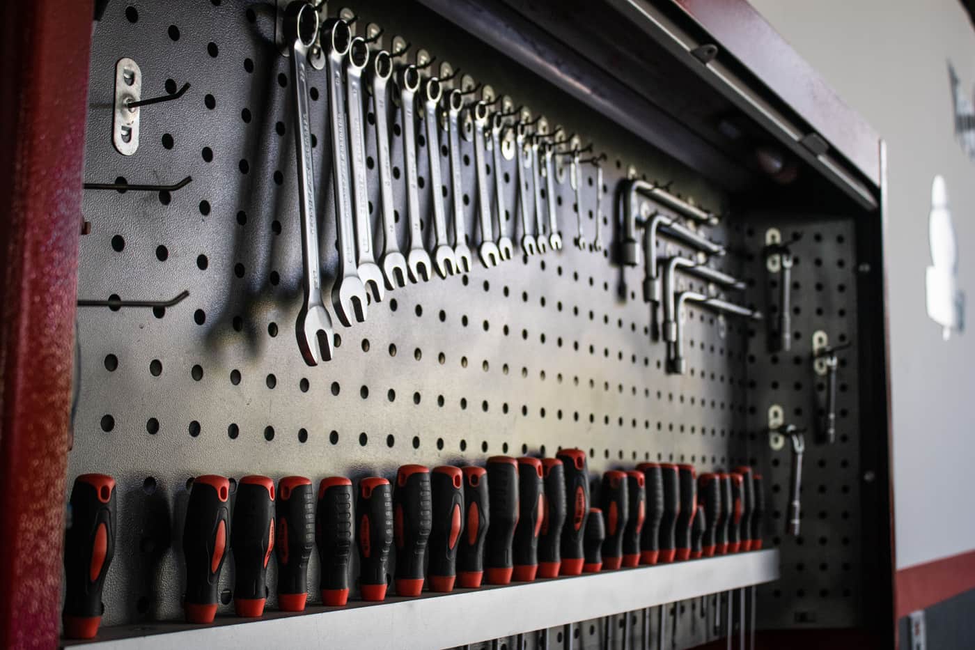 Hand tools hanging on a pegboard display