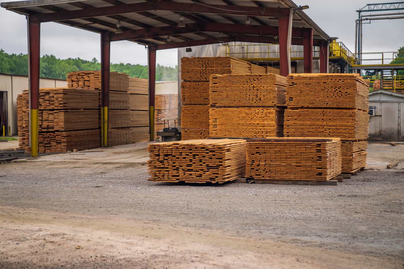Stacked lumber and building supplies in a yard