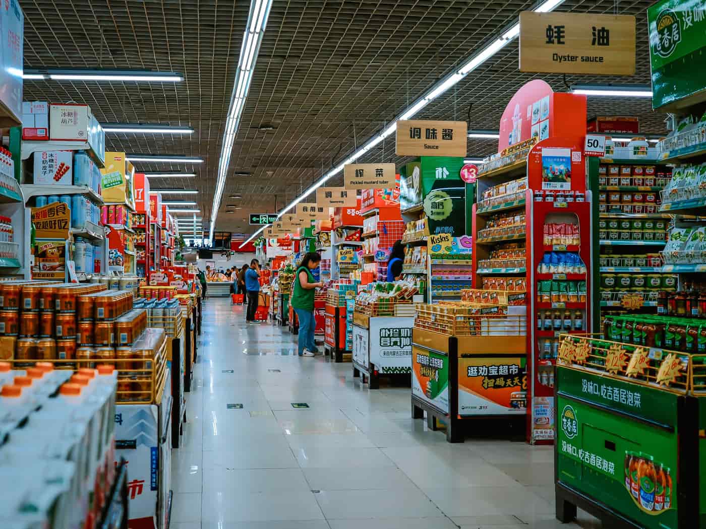 A wide supermarket aisle lined with shelving