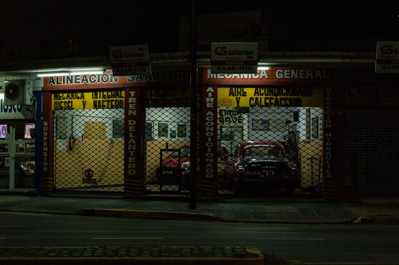 A garage workshop lit by a portable work light at night