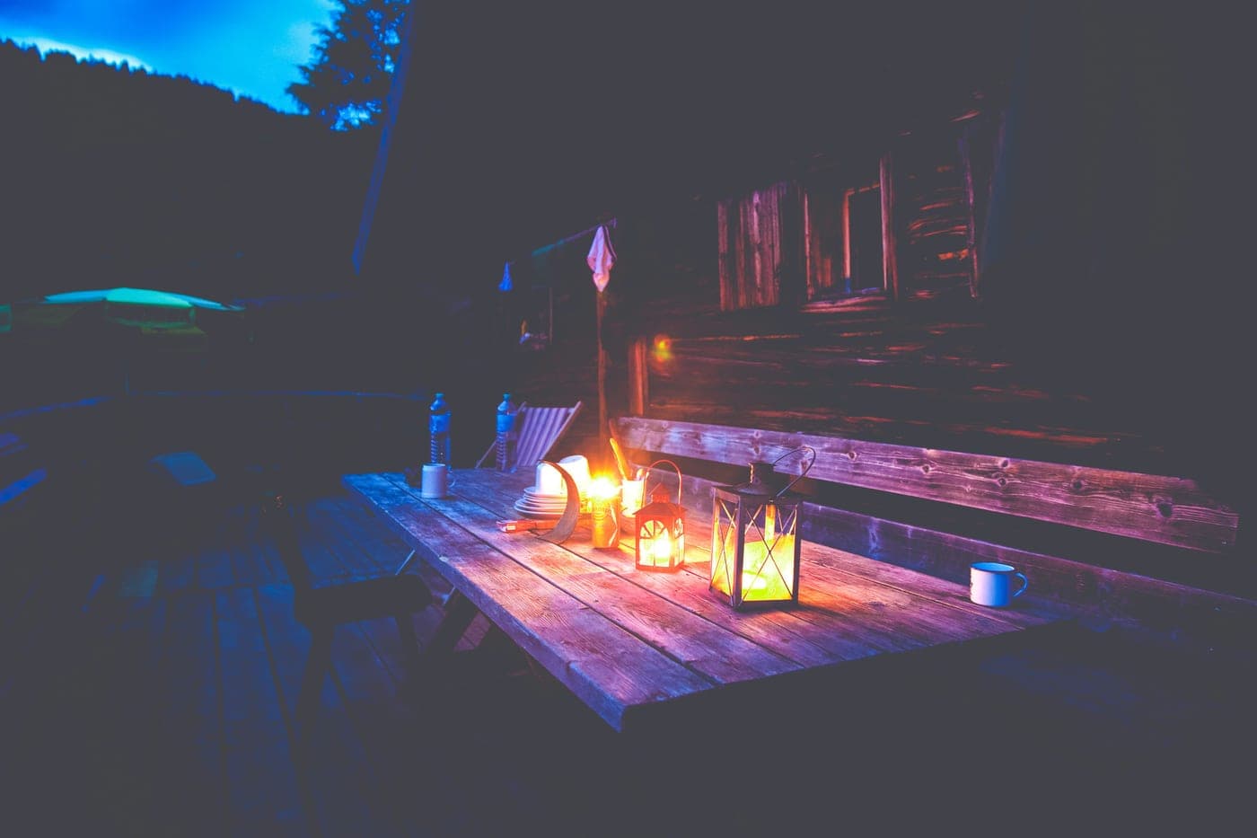 A lantern glowing on a table in a dark room