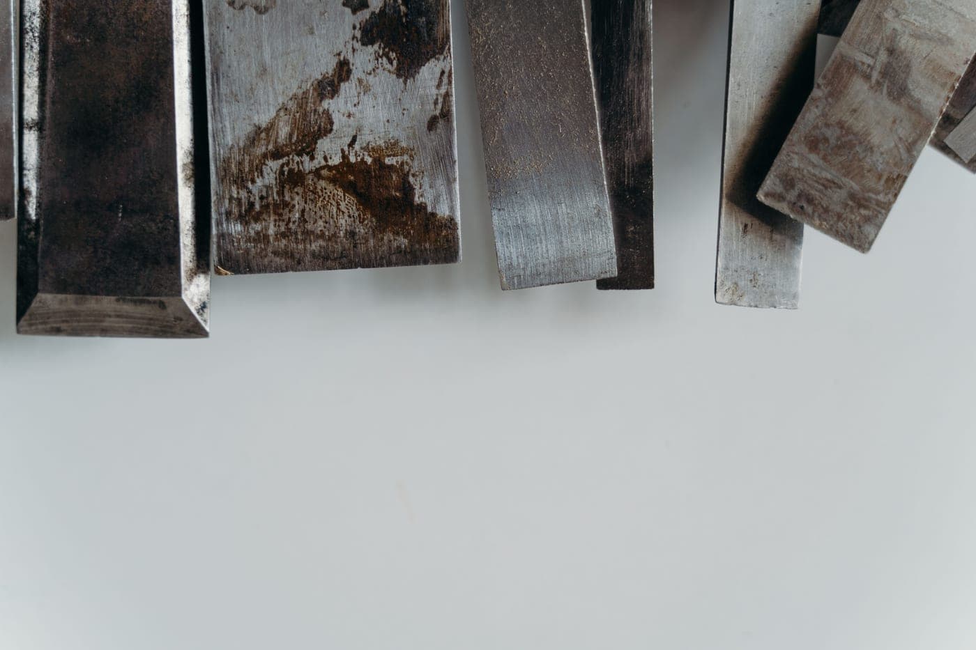 Metal hand tools resting on a steel surface