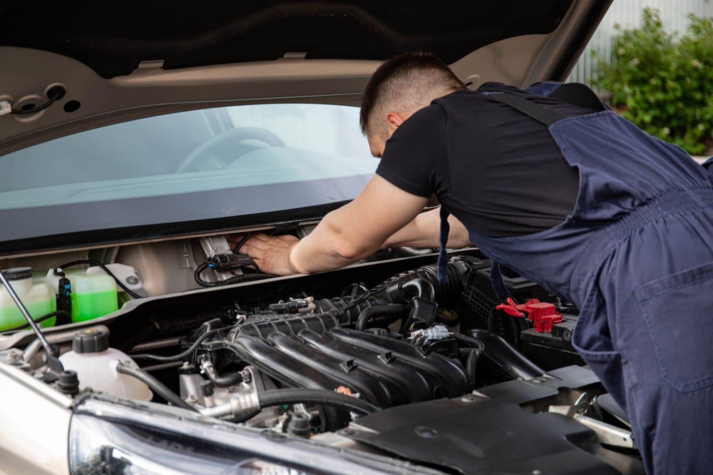 An engine bay illuminated by a portable work light